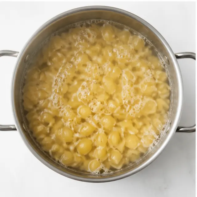 Step 3: Boiling small shell pasta in salted water until al dente