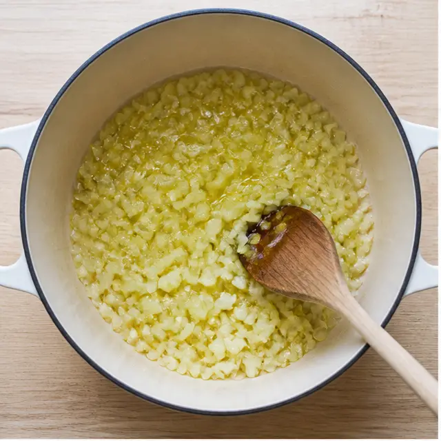 Sauté diced yellow onion in olive oil until translucent