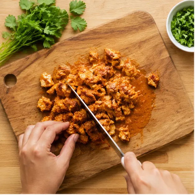 Step 1: Chopping the cooked tikka masala chicken into bite-size pieces