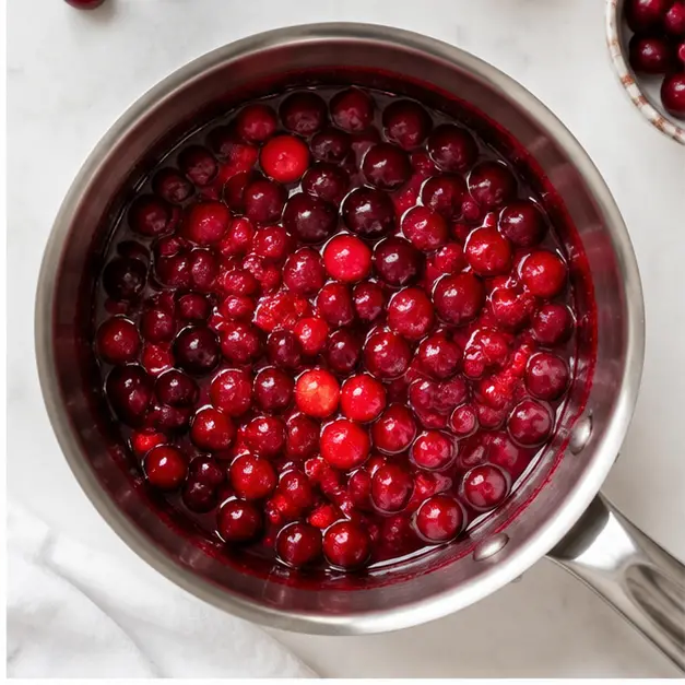 Step 2: Cook cranberries with maple syrup and orange juice until berries burst