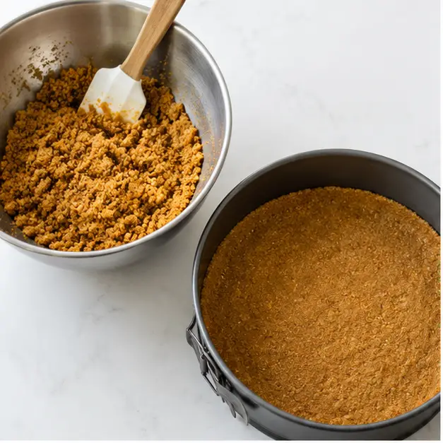 Step 1: Pressing the gingersnap butter crumb mixture into the springform pan