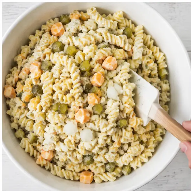 Step 4: Folding dressed rotini pasta salad with pickles, onion, and Colby Jack cheese