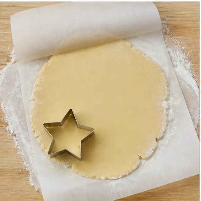 Step 3: roll the no-chill dough flat between parchment sheets and press star cookie cutters into the dough