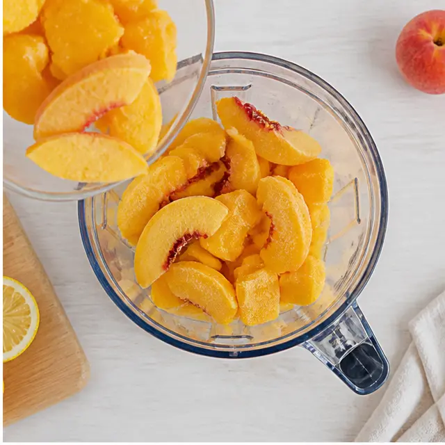 Step 2: Add frozen peaches and mango chunks