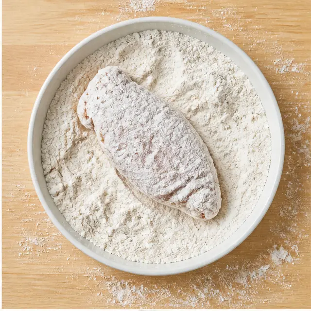 Step 2: Dredging the chicken in seasoned flour