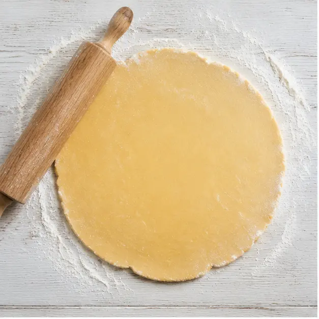 Roll out the refrigerated pie crust into a 14-inch round and press it into a buttered tart pan.