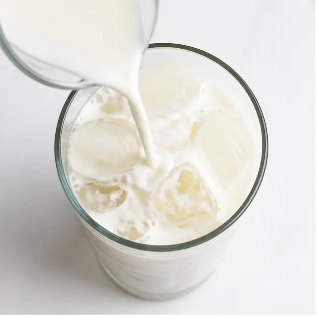 Step 1: Pouring cold milk over ice in a tall glass