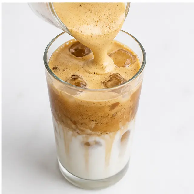 Step 4: Pouring the foamy espresso over iced milk