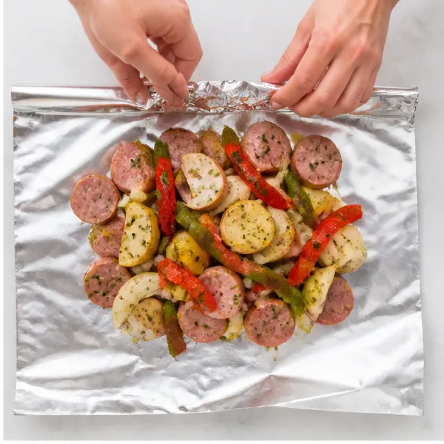 Step 2: Piling the mixture onto foil sheets and folding the edges tightly to seal the packets.