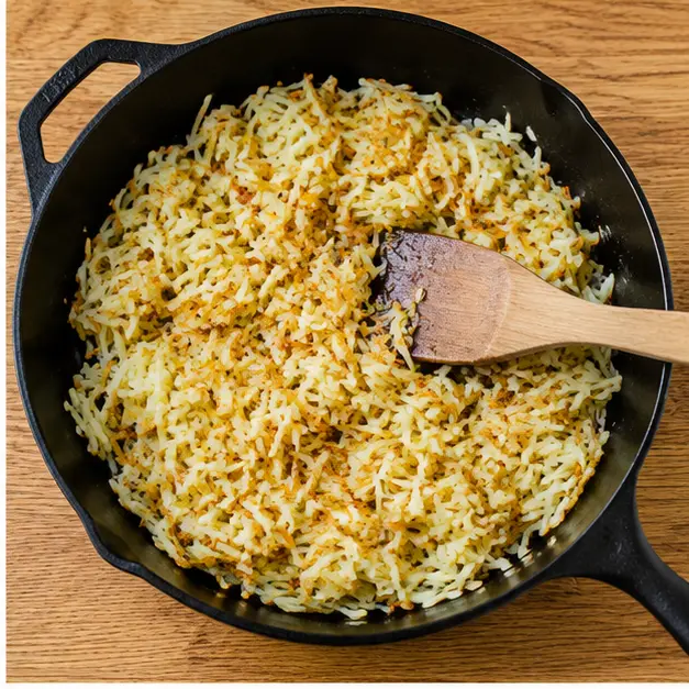 Step 2: Cooking frozen shredded hash browns in the same skillet until golden and crispy