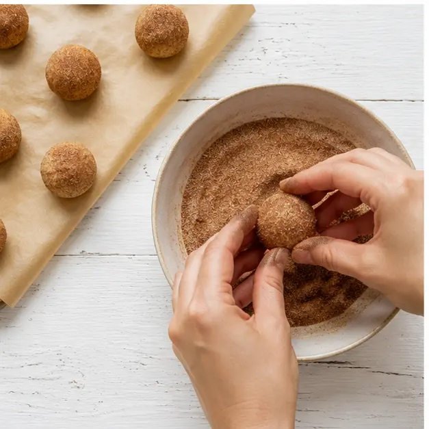 Roll dough balls in the cinnamon sugar coating just before baking